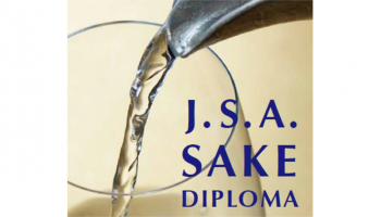 片口からグラスに日本酒が注がれている写真。その上に「J.S.A. SAKE DIPLOMA」のロゴ