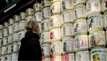 日本酒の酒樽を畏敬の念をもって眺める外国人